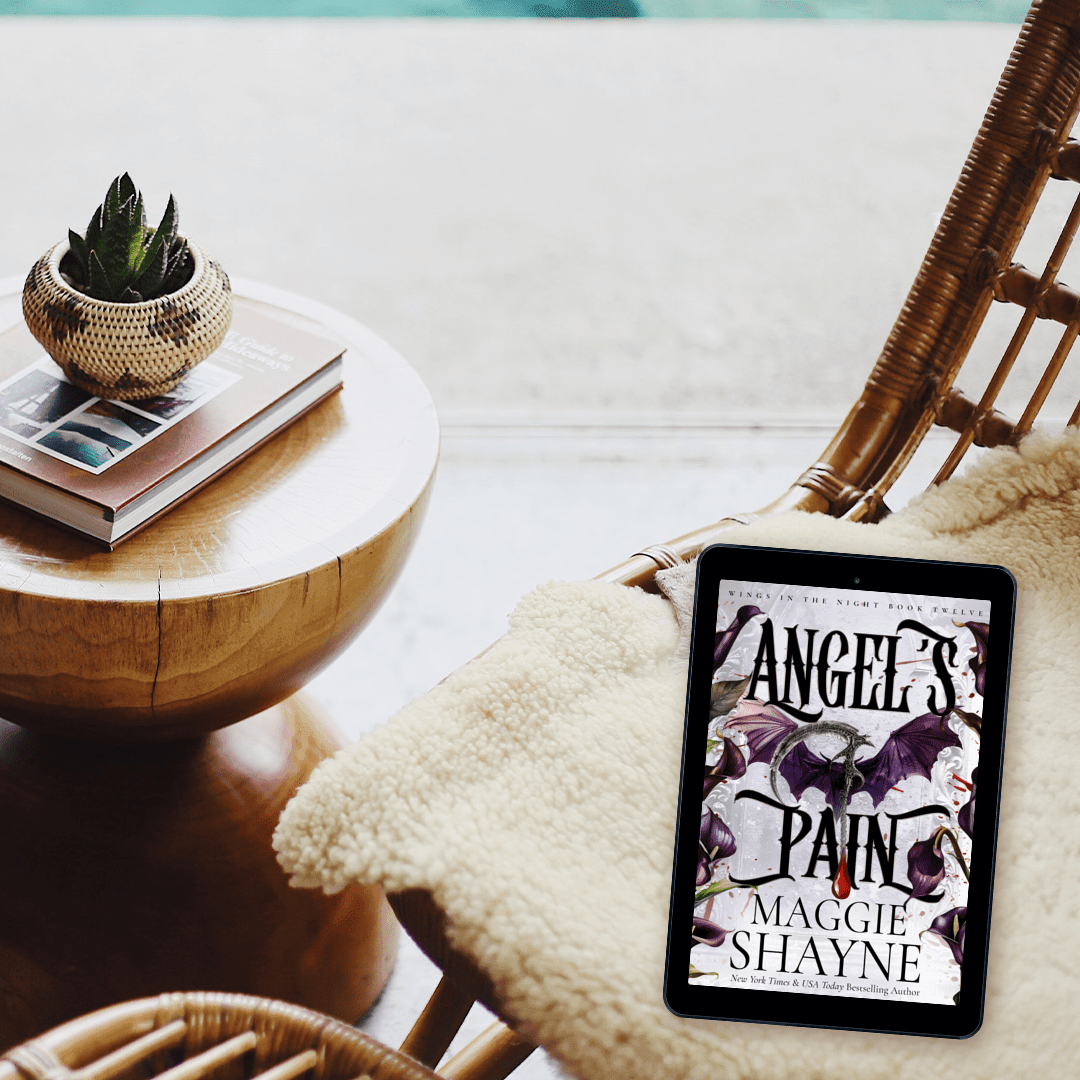 Maggie Shayne's Angel's Pain Lifestyle 3 ebook cover on blanket on wicker chair, coffee table with books and cactus