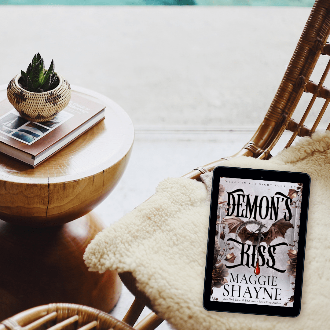 Maggie Shayne's Demon's Kiss Lifestyle 3 ebook cover, wicker chair, blanket, coffee table, cactus, book